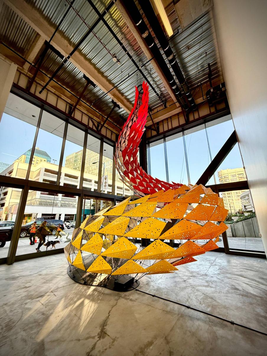 abstract art piece with vibrant orange and red panels curving upward