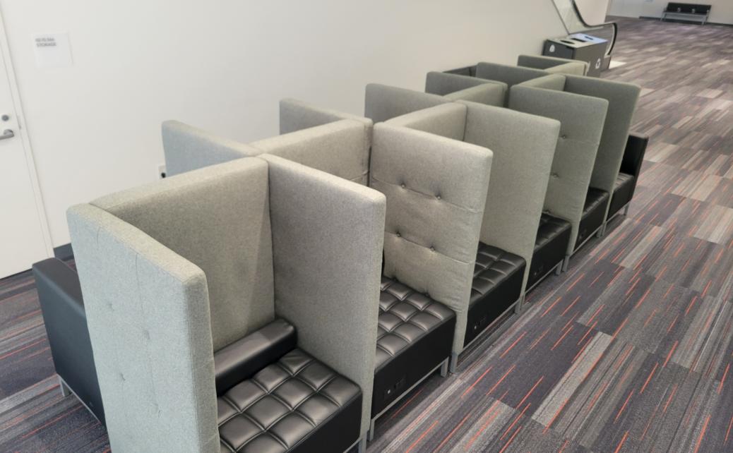 photo of privacy lounge with grey and black privacy chairs