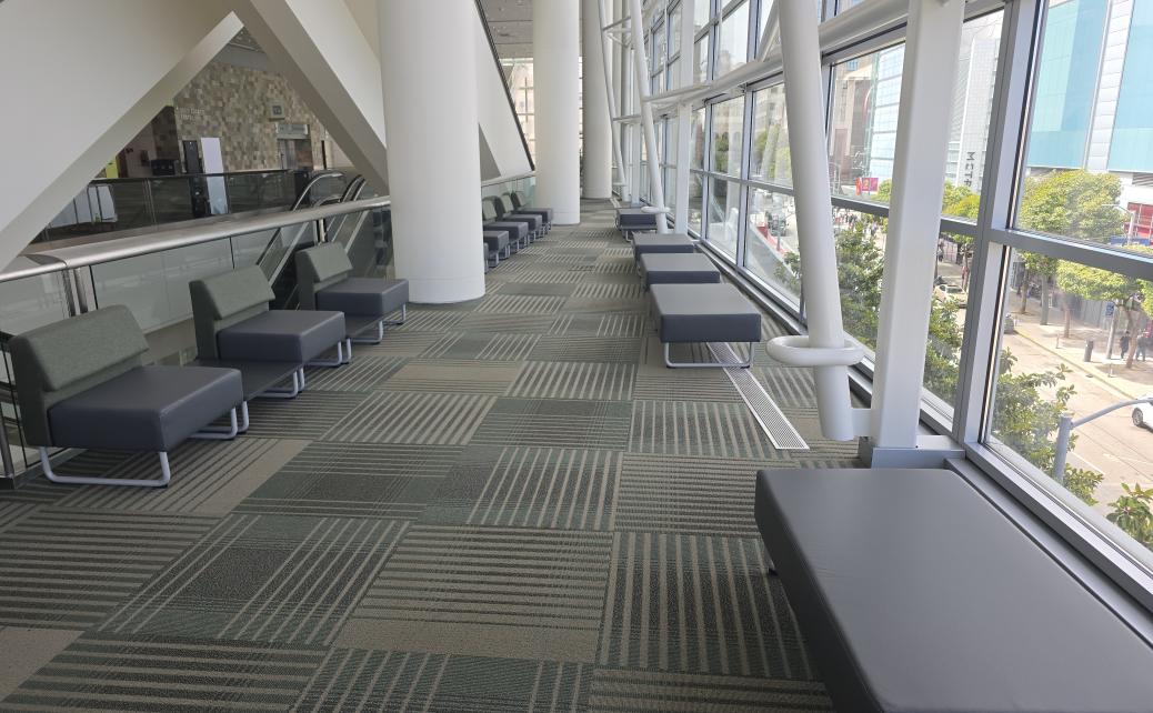 photo of green & black benches and chairs in lounge overlooking 4th Street