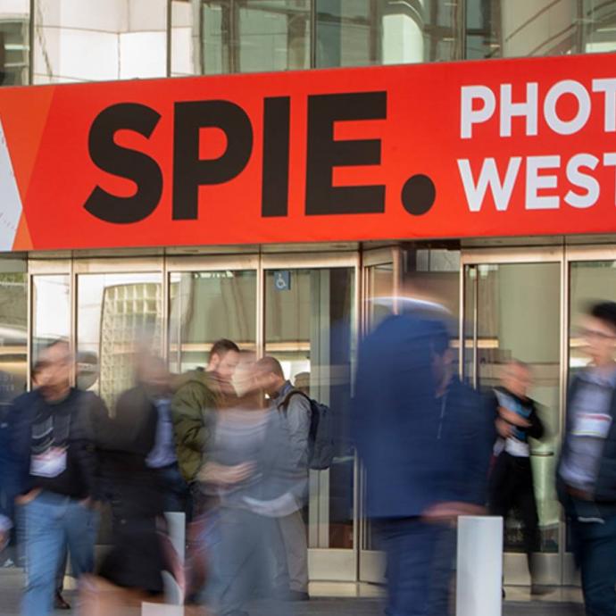 blurry photo of people crossing the street to enter SPIE Photonics West event