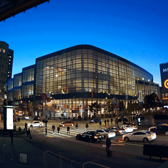 Like a lantern, Moscone West is illuminated at night.