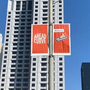 street view of highrise hotel with welcome banners on lightpoles