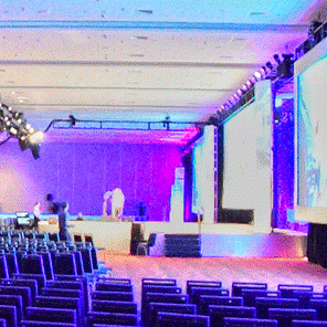 A general session enhanced with theatrical lighting is set up in Moscone South Level 2 Rooms 202-204.