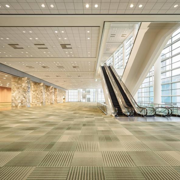 view of Moscone West lobby showing carpet and escalators, no people